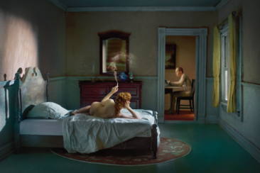 1940s bedroom scene with a nude woman lying on bed. u.s.A