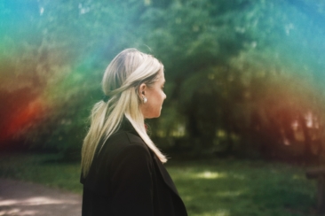 woman in black shirt standing on green grass field during daytime