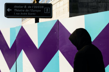 person wearing black pullover hoodie walking on street during daytime