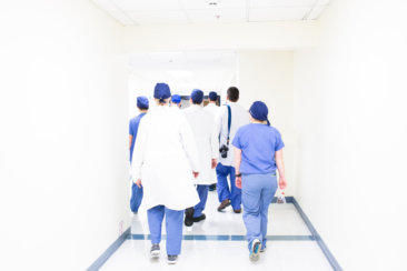 group of doctors walking on hospital hallway