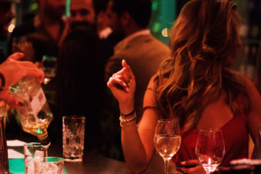 woman sits on the bar