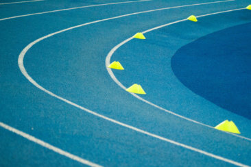 blue curved track field at daytime