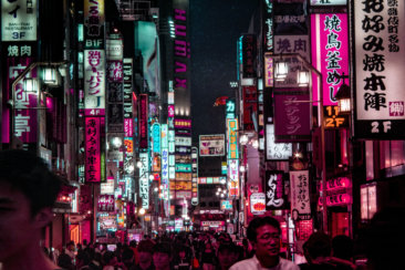 people walking on street during night time