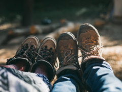 person in blue denim jeans and brown hiking shoes