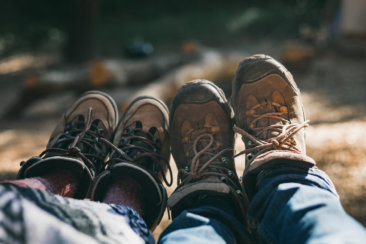 person in blue denim jeans and brown hiking shoes