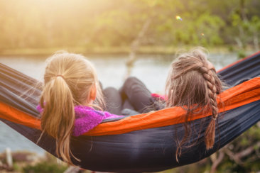 two women lying on hammock