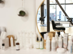 black and silver office rolling chair beside mirror