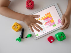 person holding white ipad on white table