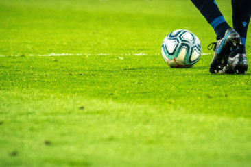 man playing soccer game on field