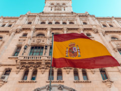 flag on pole beside building during day