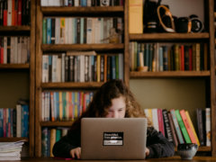 woman in black long sleeve shirt using macbook