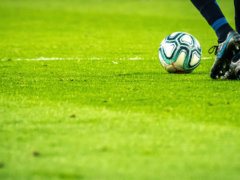 man playing soccer game on field