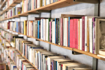 books on brown wooden shelf