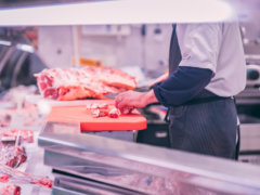 man slicing raw meat