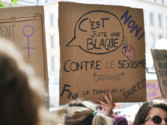 person holding cardboard sign