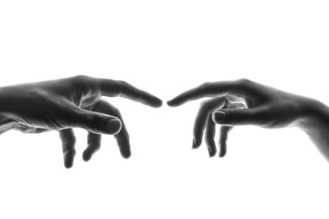 two person's connecting fingers