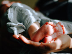 person holding baby feet