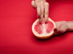 person holding sliced orange fruit