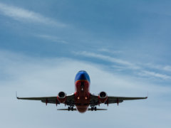 blue and red airplane on sky