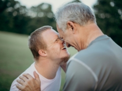 two man talking to each other on grass field