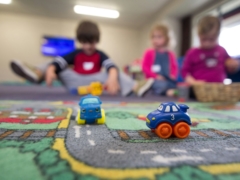 a group of children playing with toys on the floor