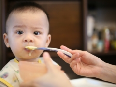 person feeding baby